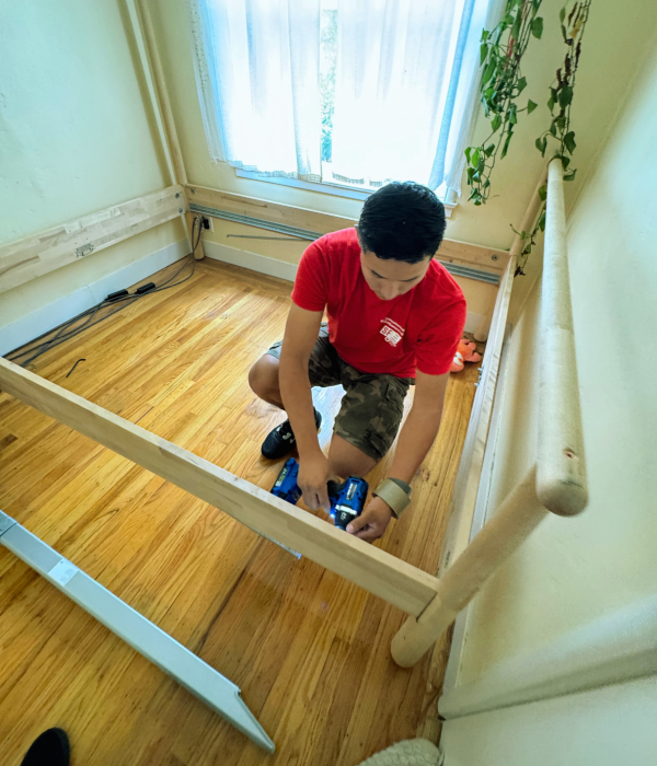 Moving crew member disassembling furniture before transport