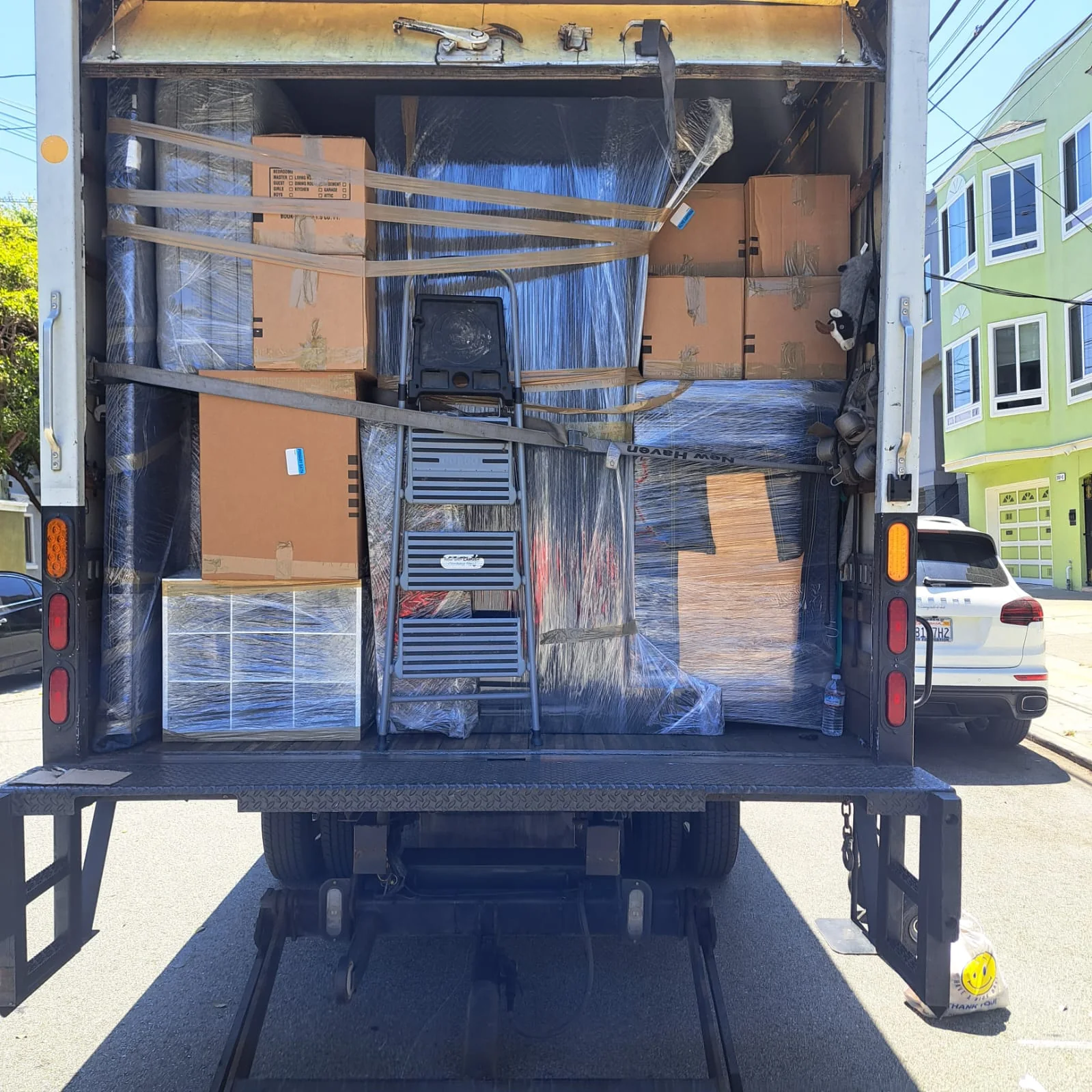 Organized SF Bay Area Moving truck loaded with secured boxes and wrapped furniture.